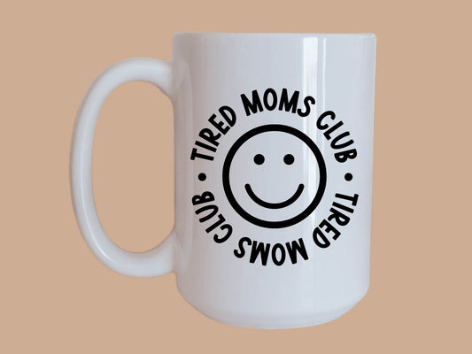 https://tiredmama.co/cdn/shop/products/tired-moms-club-smile-coffee-mug-141930.jpg?v=1674996079&width=533